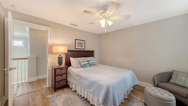 bedroom with light hardwood / wood-style floors and ceiling fan