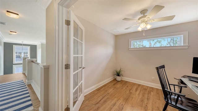 office space with ceiling fan, plenty of natural light, light hardwood / wood-style flooring, and ornamental molding