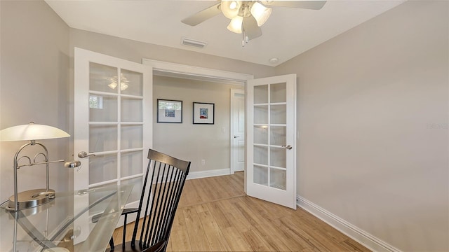 office area with ceiling fan, french doors, and light hardwood / wood-style floors