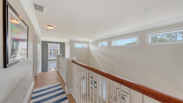 hallway featuring ornamental molding and light wood-type flooring