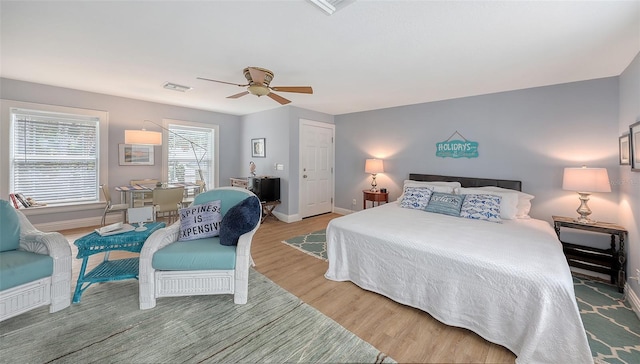 bedroom with ceiling fan and hardwood / wood-style flooring