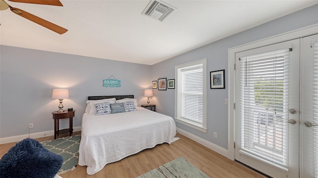 bedroom featuring wood-type flooring, access to exterior, and ceiling fan