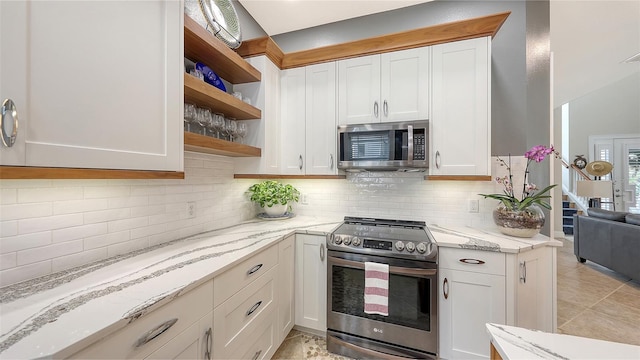 kitchen with white cabinets, light stone countertops, appliances with stainless steel finishes, and tasteful backsplash