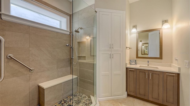 bathroom featuring vanity and a tile shower