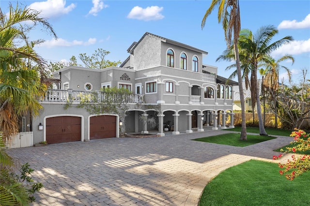 8855 Midnight Pass Rd, Sarasota, FL 34242 - mediterranean / spanish-style home with a balcony, stucco siding, a garage, and decorative driveway