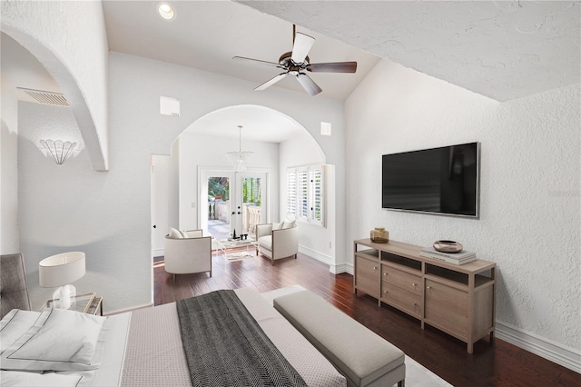 bedroom with dark hardwood / wood-style floors, ceiling fan with notable chandelier, and french doors