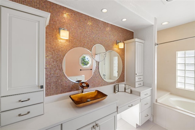 bathroom with a bathing tub, tile patterned flooring, vanity, and tile walls