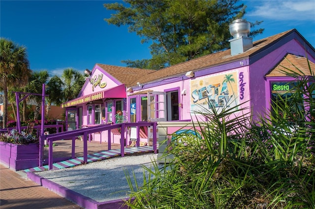 8855 Midnight Pass Rd, Sarasota, FL 34242 - rear view of house with a chimney and a shingled roof