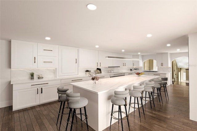 8855 Midnight Pass Rd, Sarasota, FL 34242 - kitchen with arched walkways, recessed lighting, dark wood finished floors, tasteful backsplash, and a kitchen island