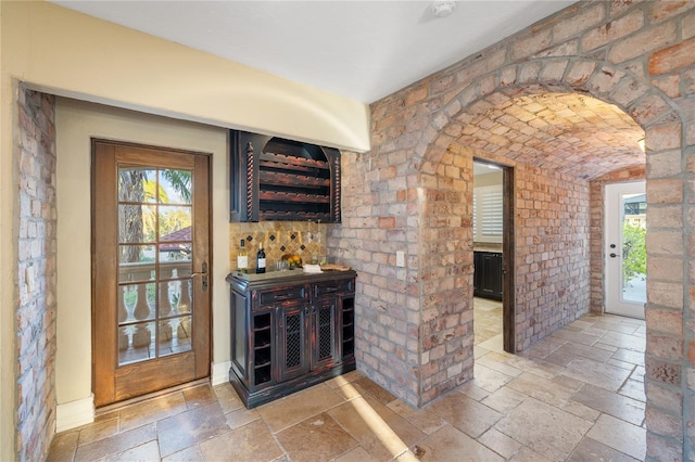 8855 Midnight Pass Rd, Sarasota, FL 34242 - indoor dry bar with stone tile flooring and arched walkways