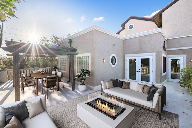 wooden deck featuring an outdoor living space with a fire pit, a pergola, a patio, and french doors