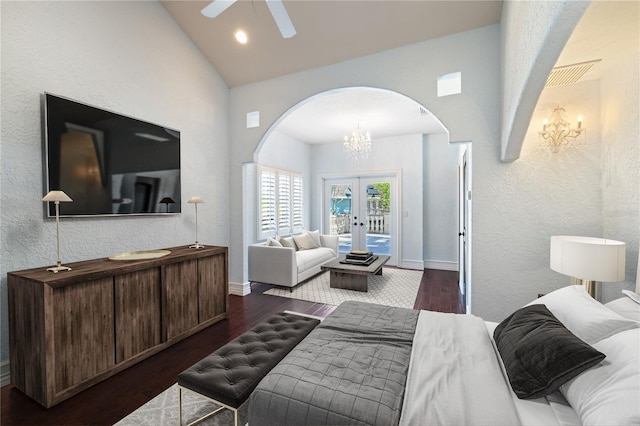 bedroom with french doors, ceiling fan with notable chandelier, access to outside, dark wood-type flooring, and high vaulted ceiling