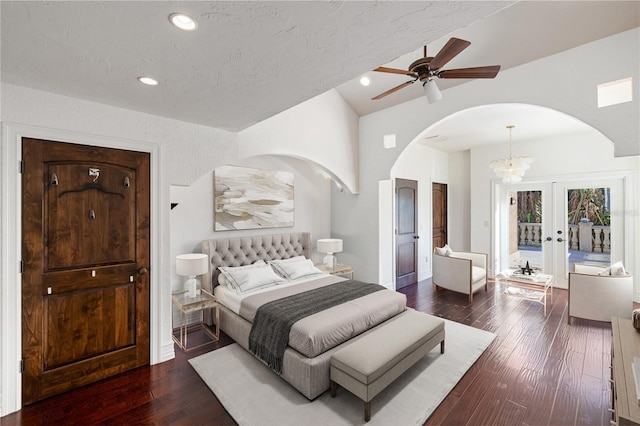 bedroom with access to exterior, french doors, dark hardwood / wood-style flooring, vaulted ceiling, and ceiling fan with notable chandelier