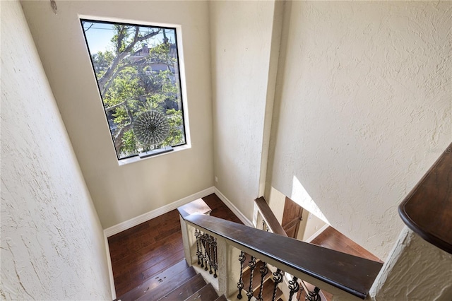 8855 Midnight Pass Rd, Sarasota, FL 34242 - staircase featuring hardwood / wood-style floors, a textured wall, and plenty of natural light