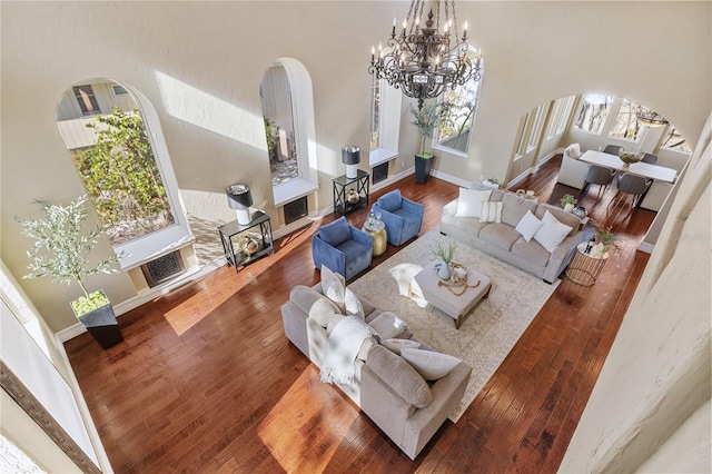 living room with wood-type flooring and a towering ceiling