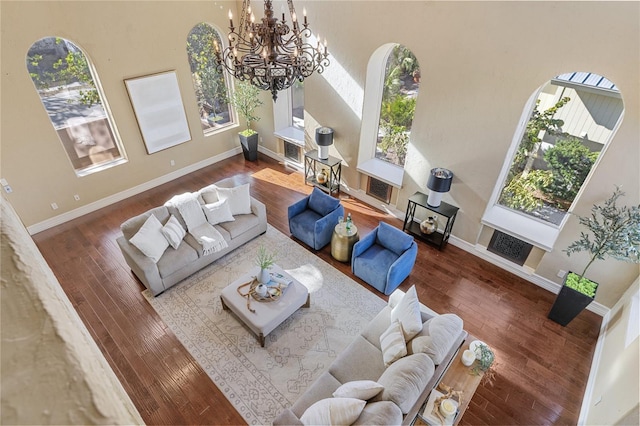 8855 Midnight Pass Rd, Sarasota, FL 34242 - living area with healthy amount of natural light, hardwood / wood-style floors, a chandelier, and a high ceiling