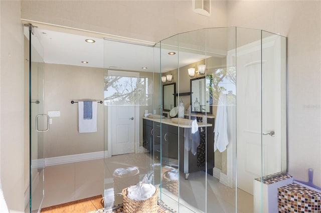 bathroom with tile patterned flooring, vanity, and an enclosed shower