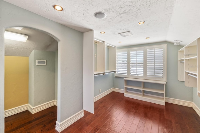 interior space featuring dark hardwood / wood-style flooring and lofted ceiling