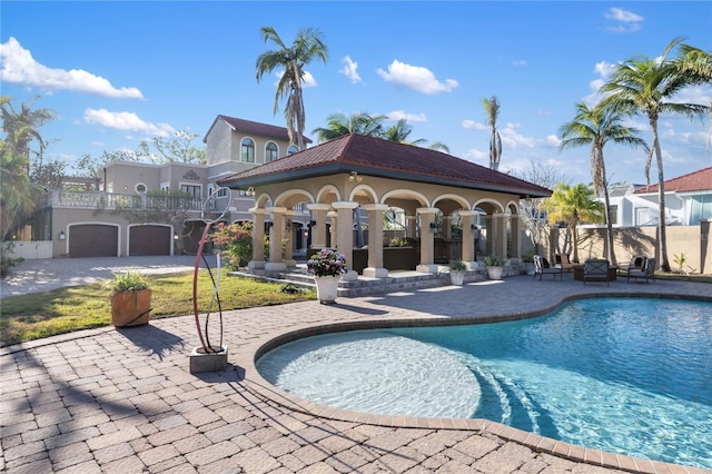 view of pool with an outbuilding and a patio