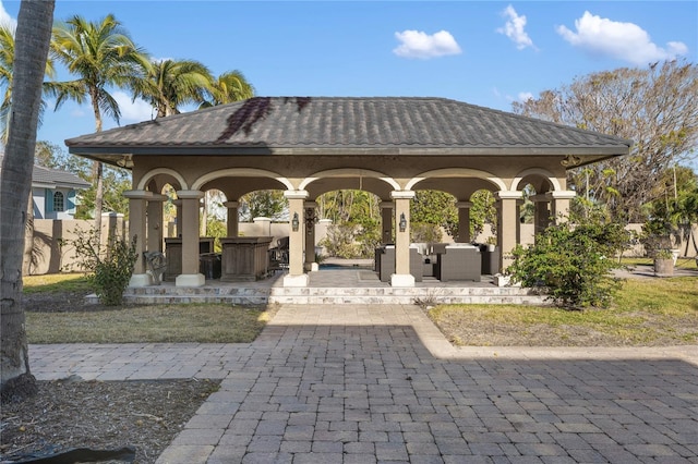 view of property's community with outdoor lounge area, a patio, and an outdoor bar