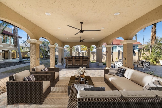 view of patio featuring an outdoor living space, an outdoor bar, and ceiling fan