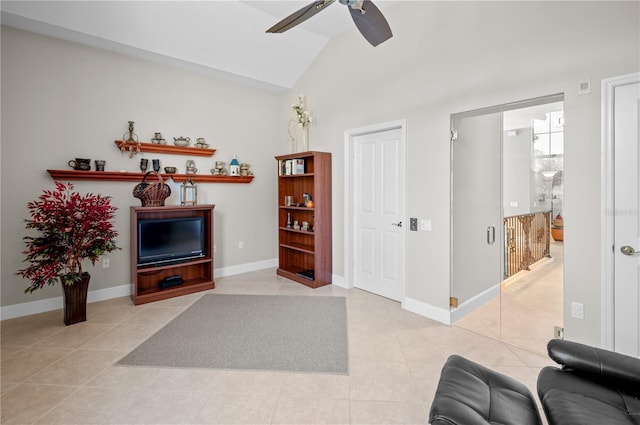 living room featuring ceiling fan, light tile patterned flooring, and vaulted ceiling