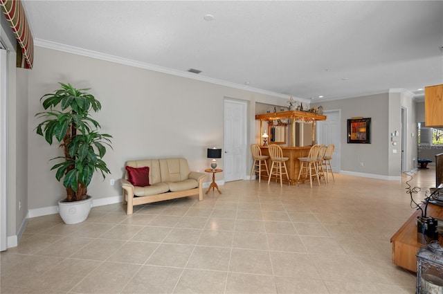 sitting room with bar, light tile patterned floors, and ornamental molding