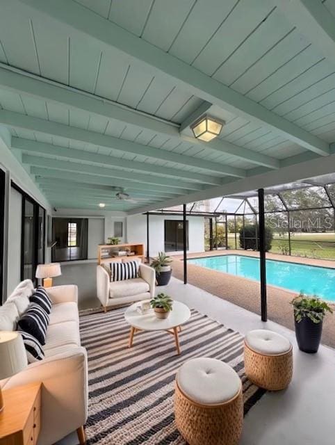 view of pool featuring outdoor lounge area, glass enclosure, and a patio