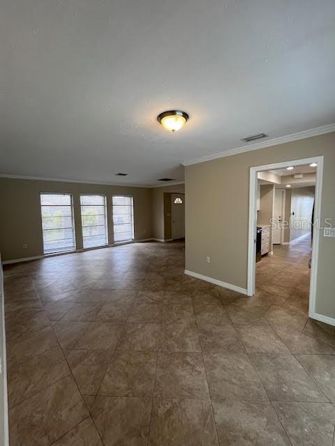 unfurnished room featuring crown molding