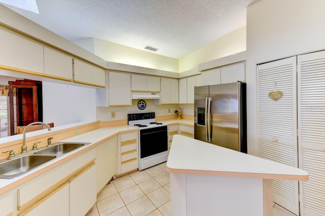 kitchen with sink, stainless steel refrigerator with ice dispenser, a textured ceiling, electric stove, and light tile patterned floors