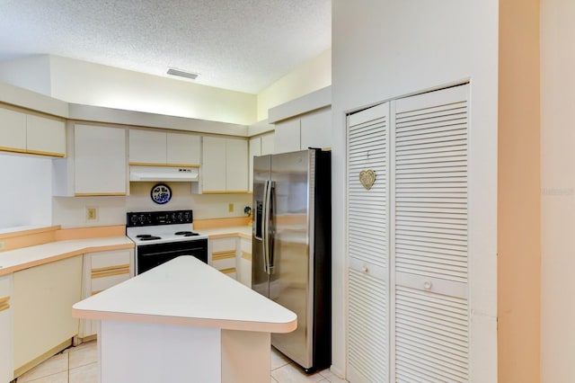 kitchen with electric range, a kitchen island, stainless steel fridge with ice dispenser, a textured ceiling, and light tile patterned floors