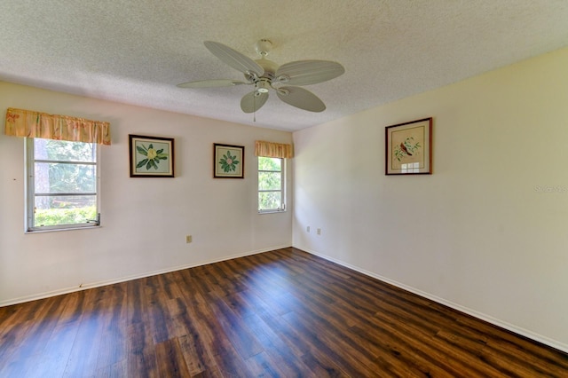 spare room featuring a textured ceiling, ceiling fan, and dark wood-type flooring