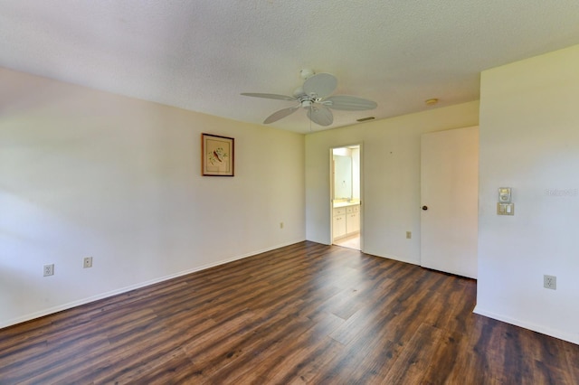 empty room with a textured ceiling, ceiling fan, and dark wood-type flooring