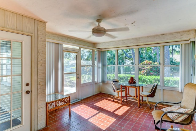 sunroom / solarium featuring ceiling fan