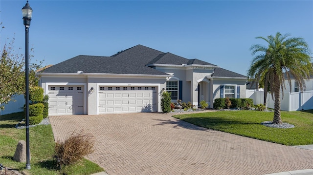 view of front facade with a front yard and a garage