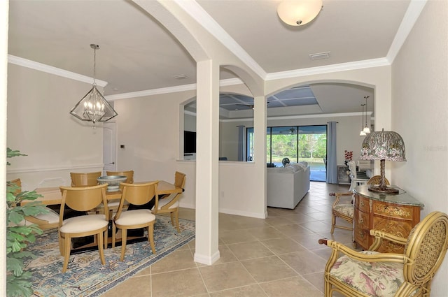 dining room featuring ornamental molding, light tile patterned floors, and an inviting chandelier