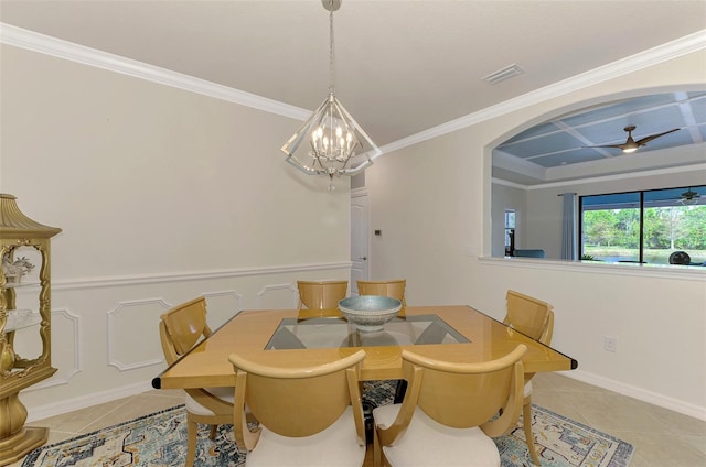 tiled dining room featuring crown molding and ceiling fan with notable chandelier