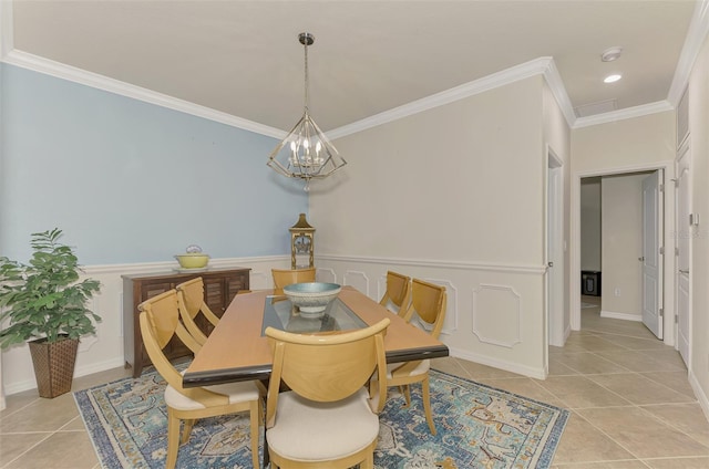 dining space with a chandelier, ornamental molding, and light tile patterned flooring