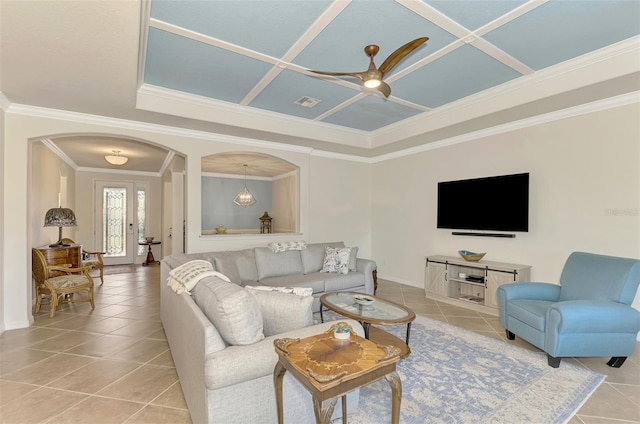 living room featuring ceiling fan, light tile patterned floors, and ornamental molding