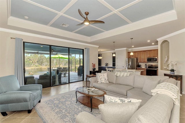 living room with ceiling fan, crown molding, light tile patterned floors, and coffered ceiling