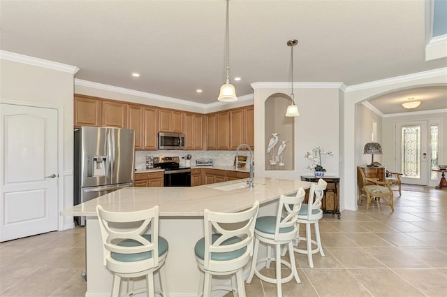 kitchen featuring pendant lighting, sink, decorative backsplash, ornamental molding, and stainless steel appliances