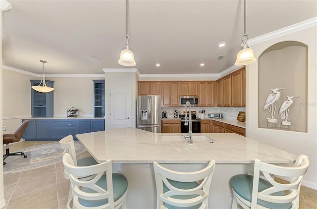 kitchen with decorative light fixtures, stainless steel appliances, and tasteful backsplash