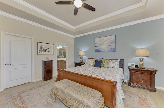 bedroom featuring light wood-type flooring, connected bathroom, ceiling fan, and crown molding