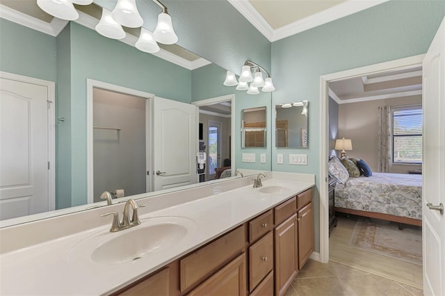 bathroom with crown molding, vanity, and a notable chandelier