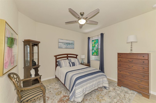 bedroom with ceiling fan and light wood-type flooring