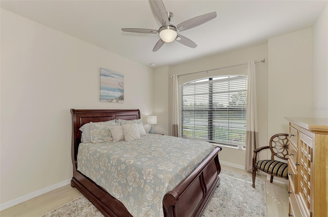 bedroom with ceiling fan and light wood-type flooring