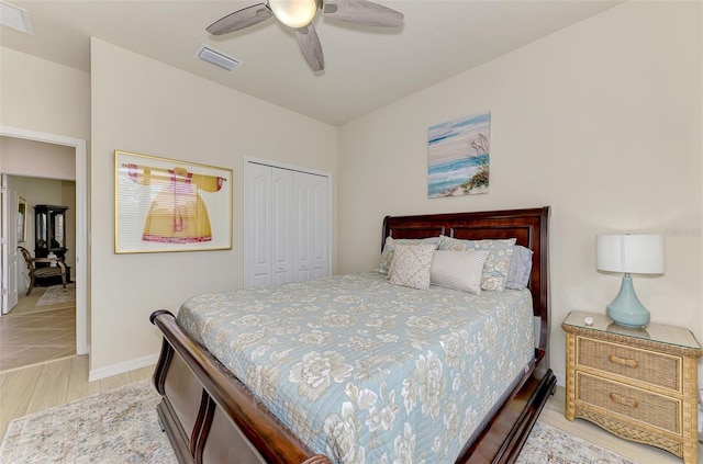 bedroom with ceiling fan, a closet, and light hardwood / wood-style flooring