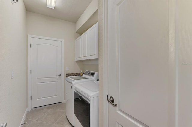 laundry area featuring cabinets, independent washer and dryer, and light tile patterned floors