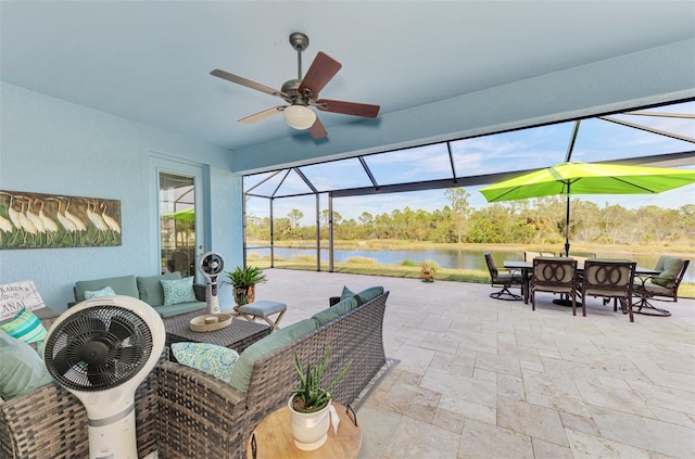 view of patio featuring outdoor lounge area, a water view, ceiling fan, and a lanai