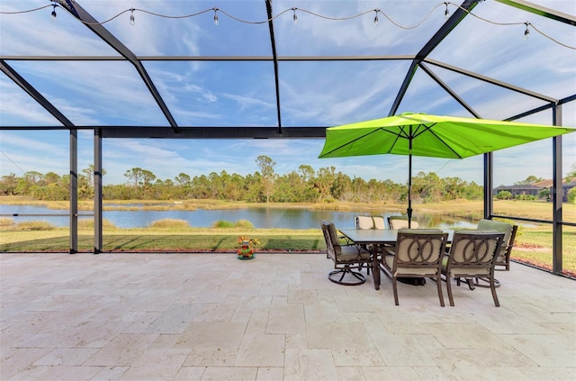 view of patio featuring a lanai and a water view